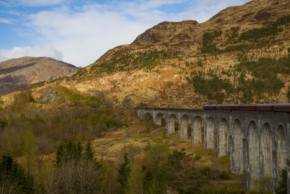 Belmond's Royal Scotsman on a bridge in the Scottish highlands