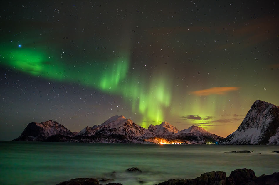 View of the Northern Lights over a village in the Lofoten Islands, Norway